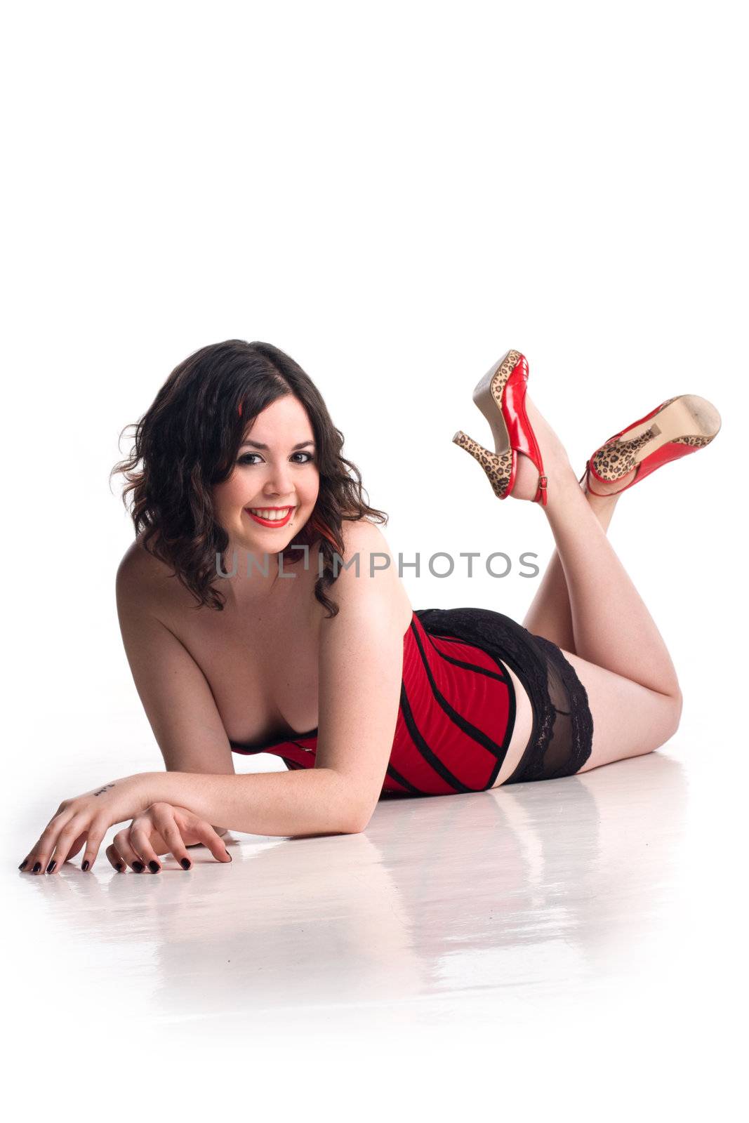 Cute girl in pin-up pose and red corset