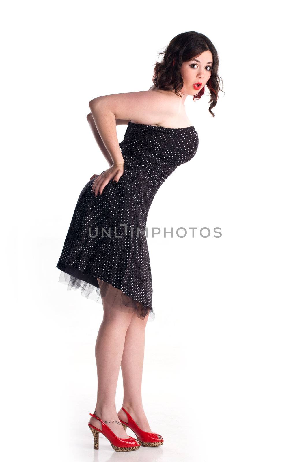 Cute girl in pin-up pose with shocked expression