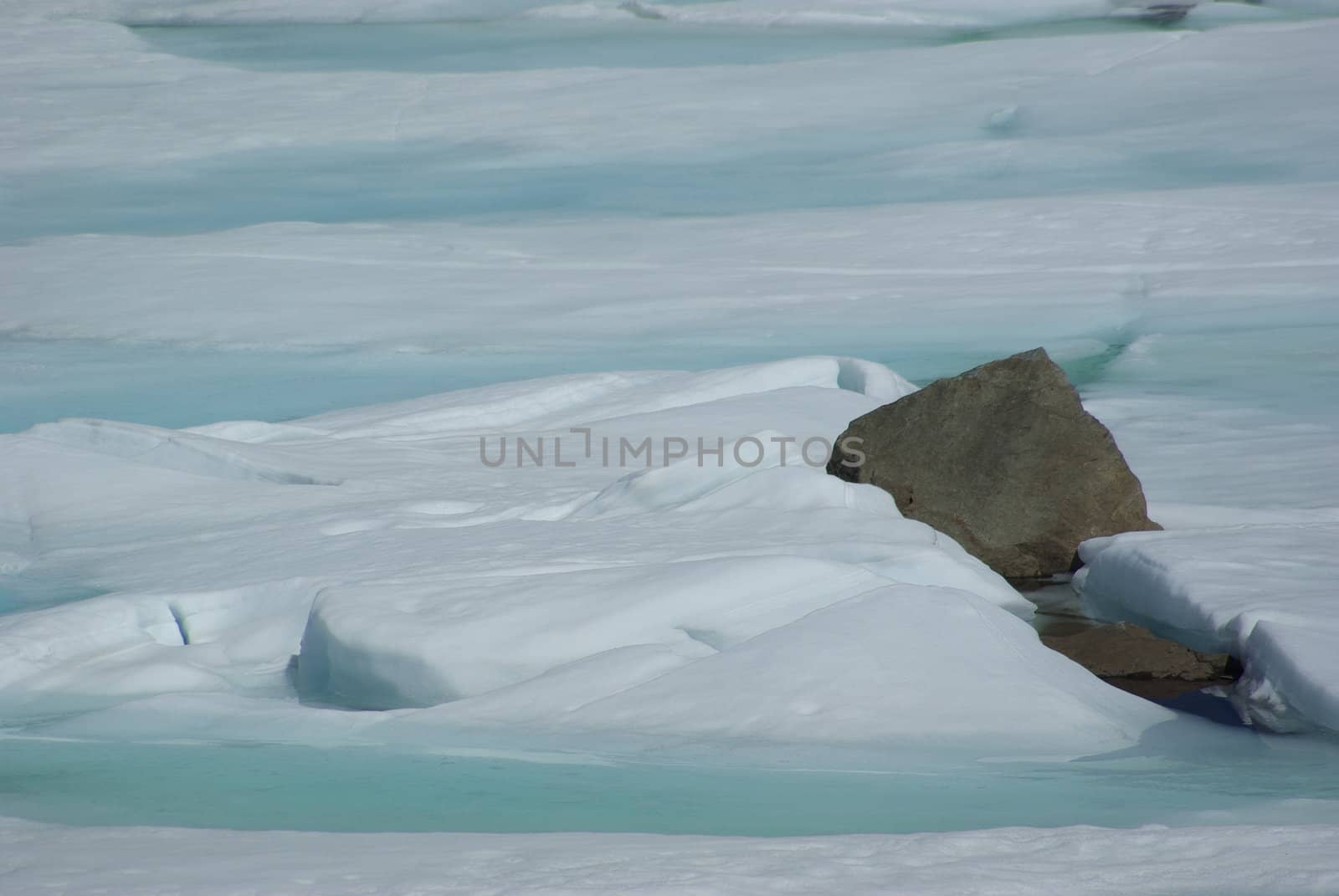 Spring ice breakup and rocks on a high Sierra lake.