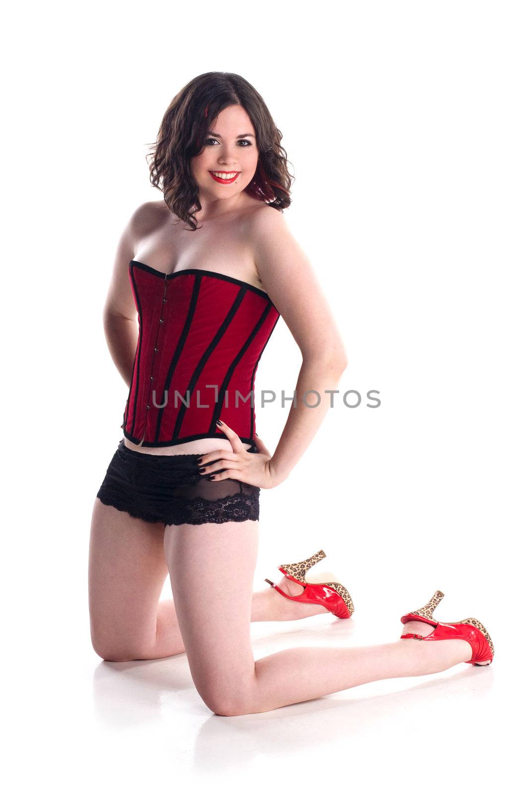 cute girl in pin-up pose in red corset by krazeedrocks