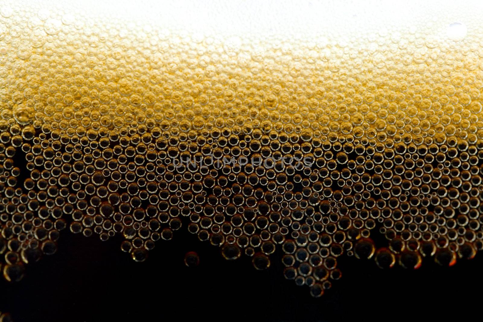 close-up appetizing dark beer with bubbles