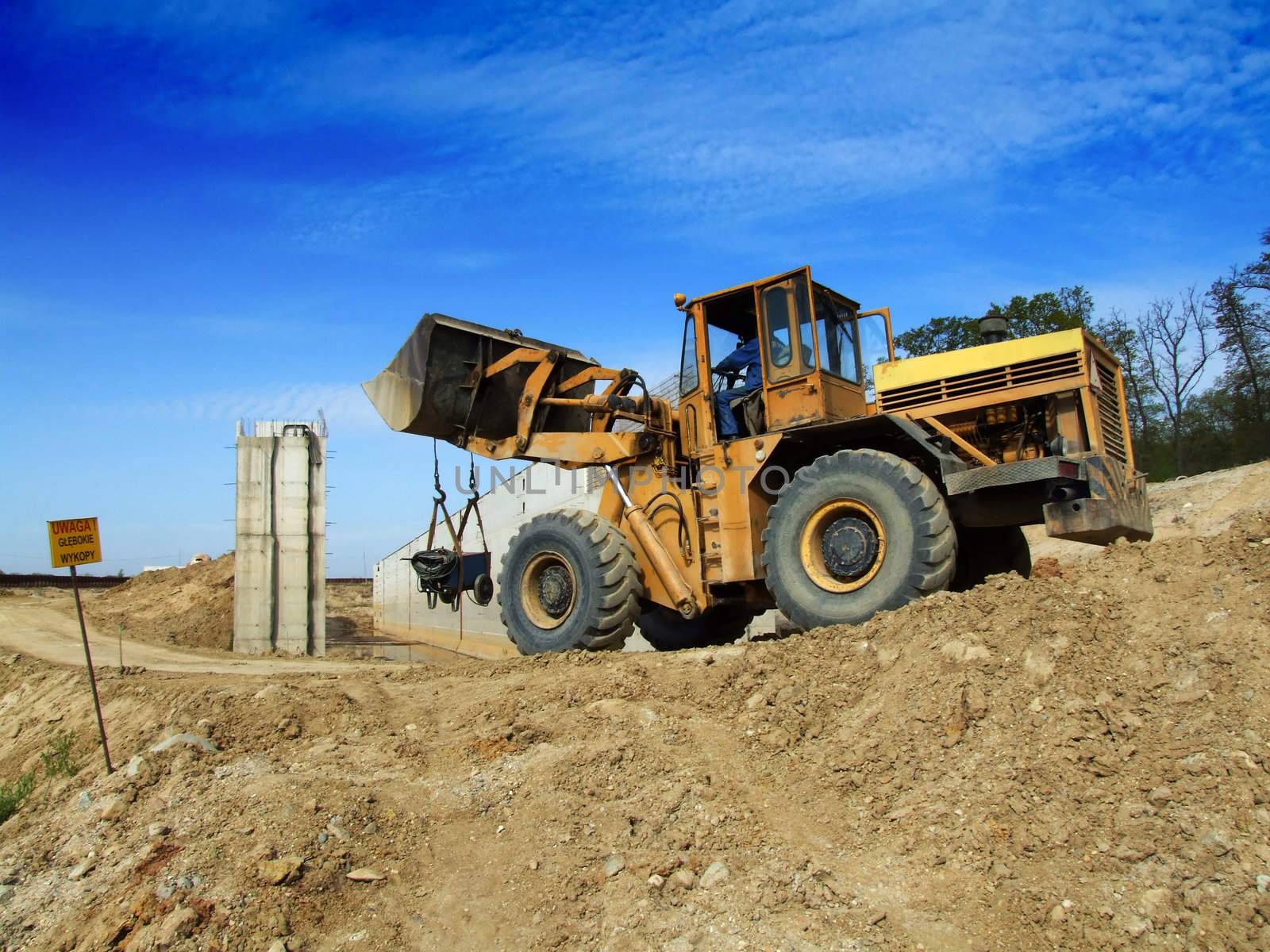 Front loader unloading concrete rubble on urban construction site