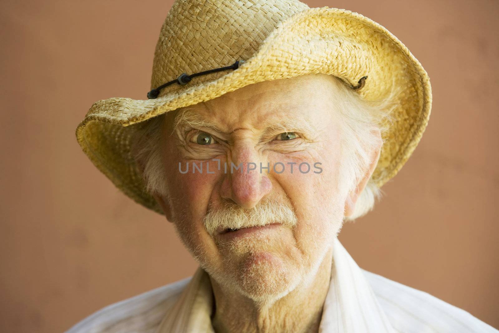 Senior Citizen Man Frowning n a Straw Cowboy Hat