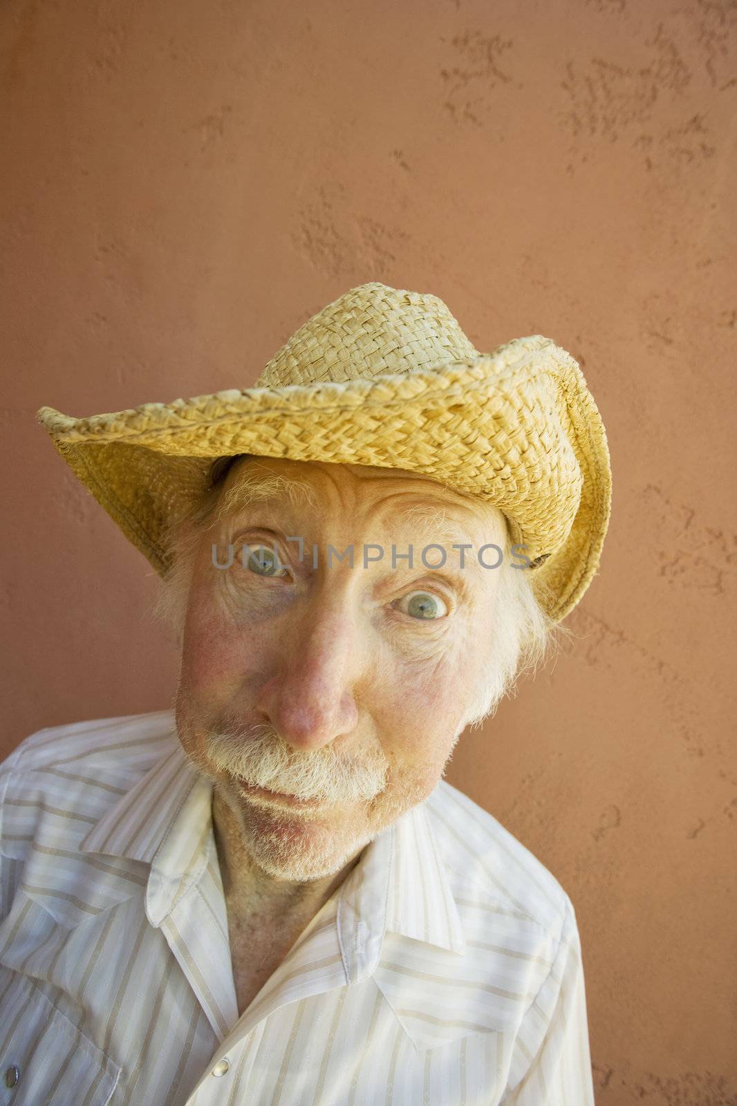 Senior Citizen Man with a Funny Expression Wearing a Straw Cowboy Hat