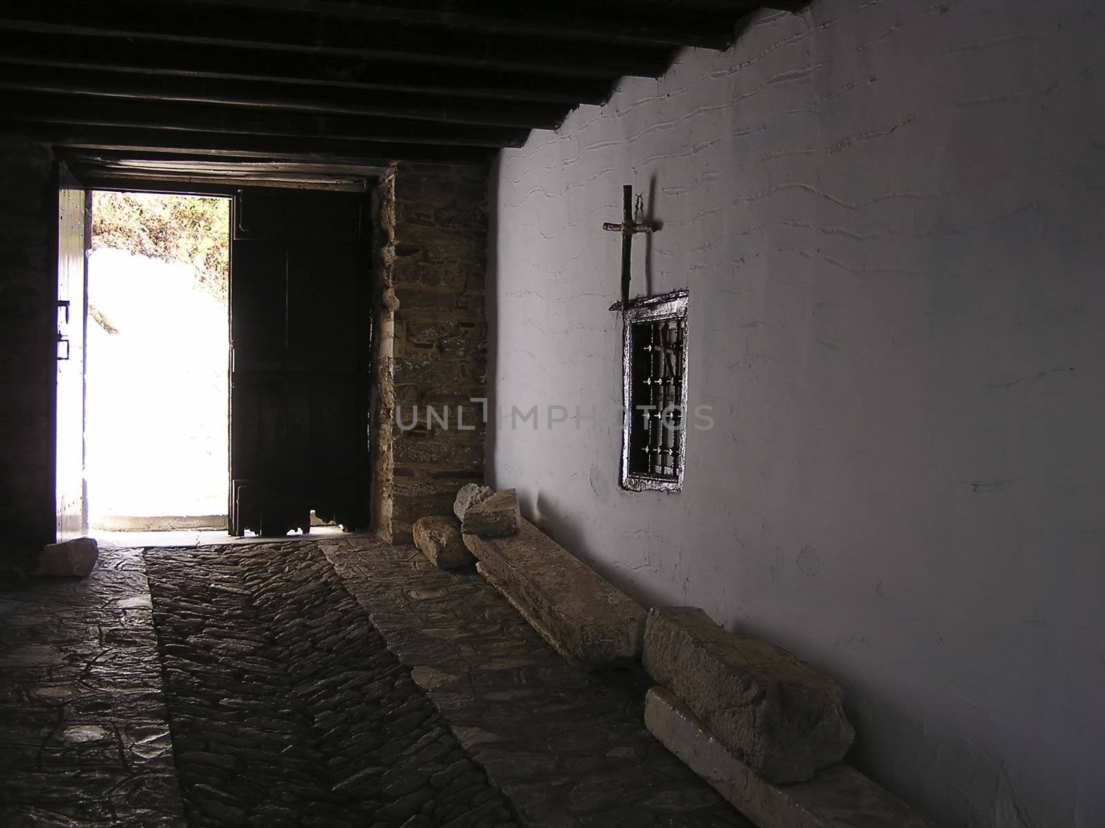 Entrance to old greek monastery at Skiathos island shot in backlight.