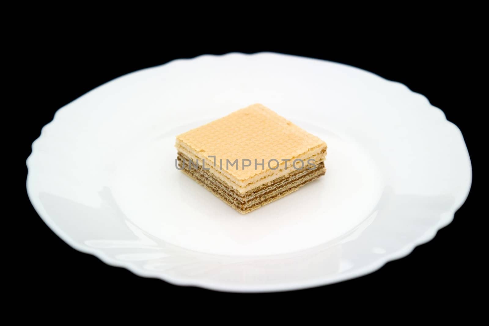 waffle on a white plate on a black background