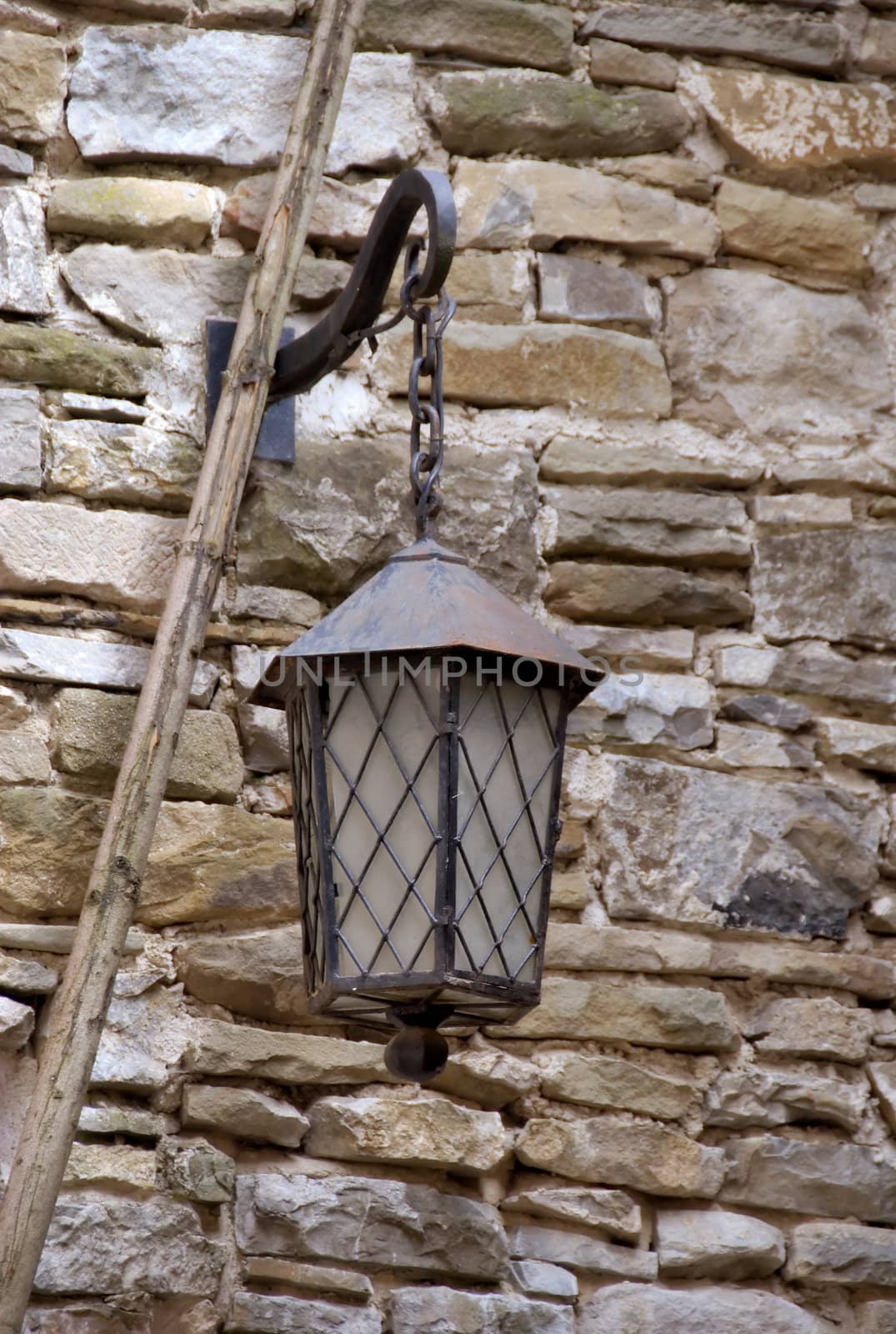 authentic historical lamp on the stone wall