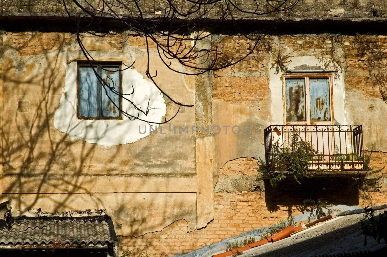 Decayed windows on old house facade