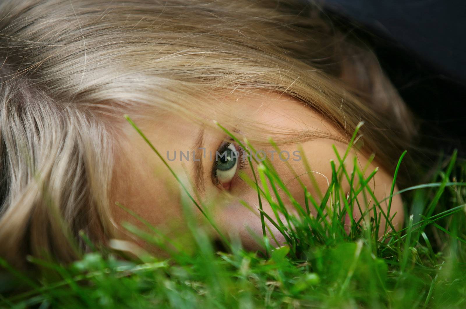 The girl in a grass. The face close-up