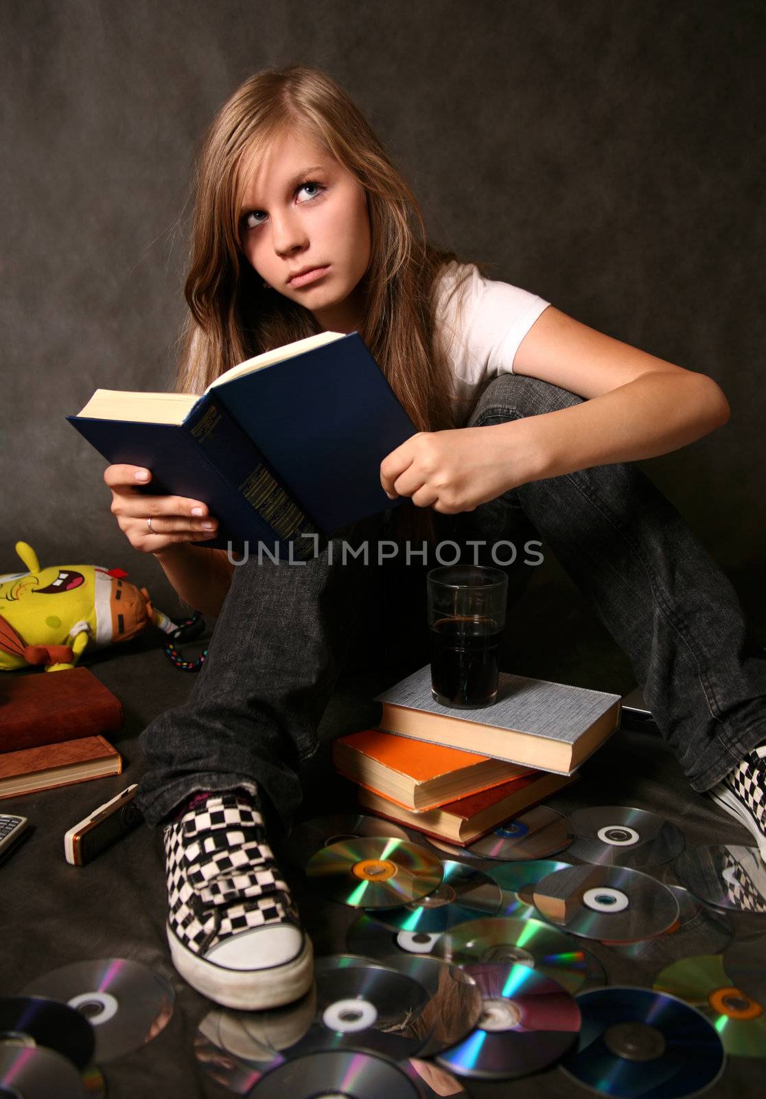 The young girl reads the book