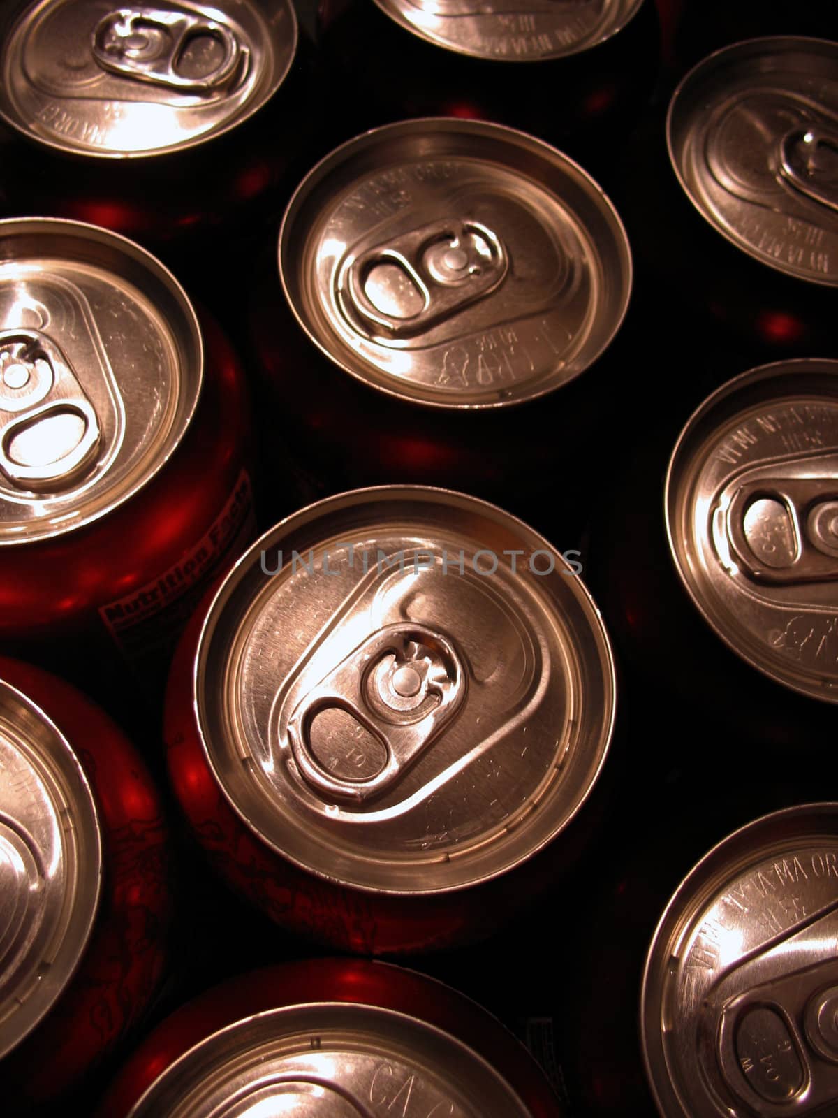 Macro shot of the tops of a bunch of aluminum cans.