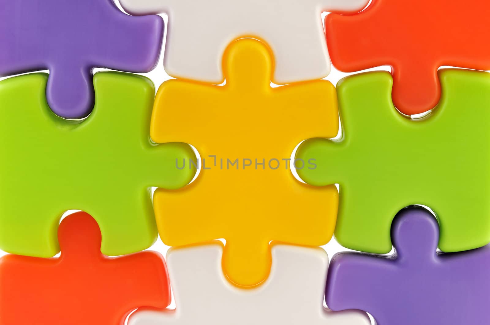 Nine colorful puzzle pieces together