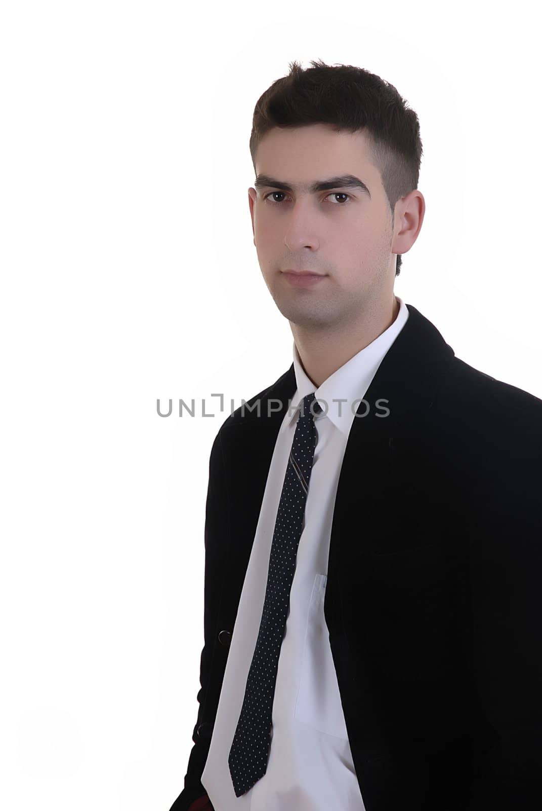 young serious man standing in a white background