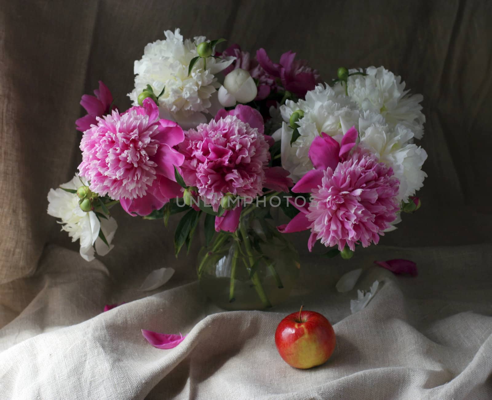Flowers and apple on the table in house interior