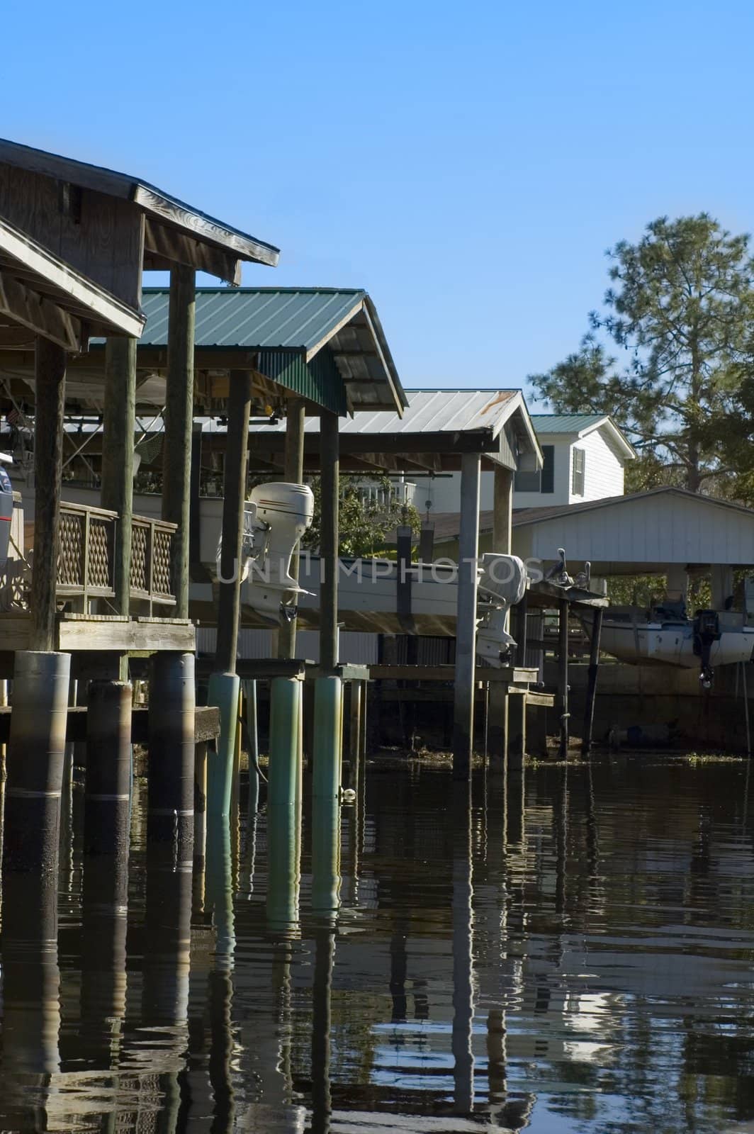 Boat houses on the canal in Suwannee, Florida.