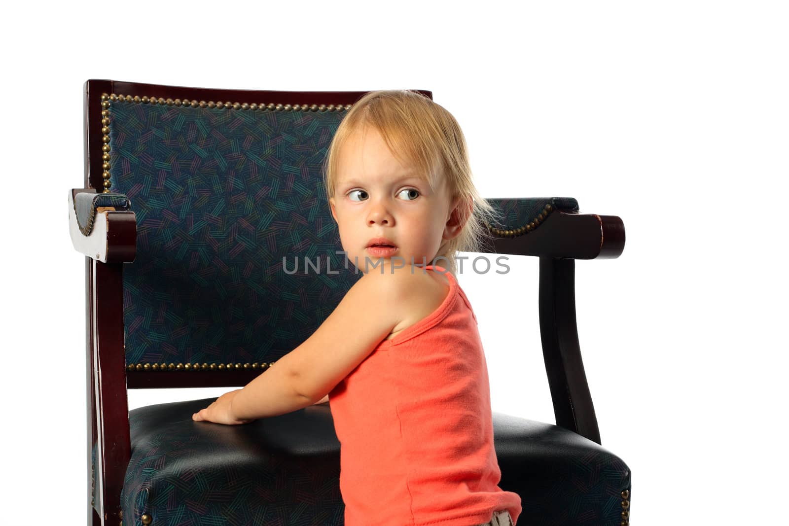 little beauty girl stand near elbow-chair lean it's elbows look around and look back
