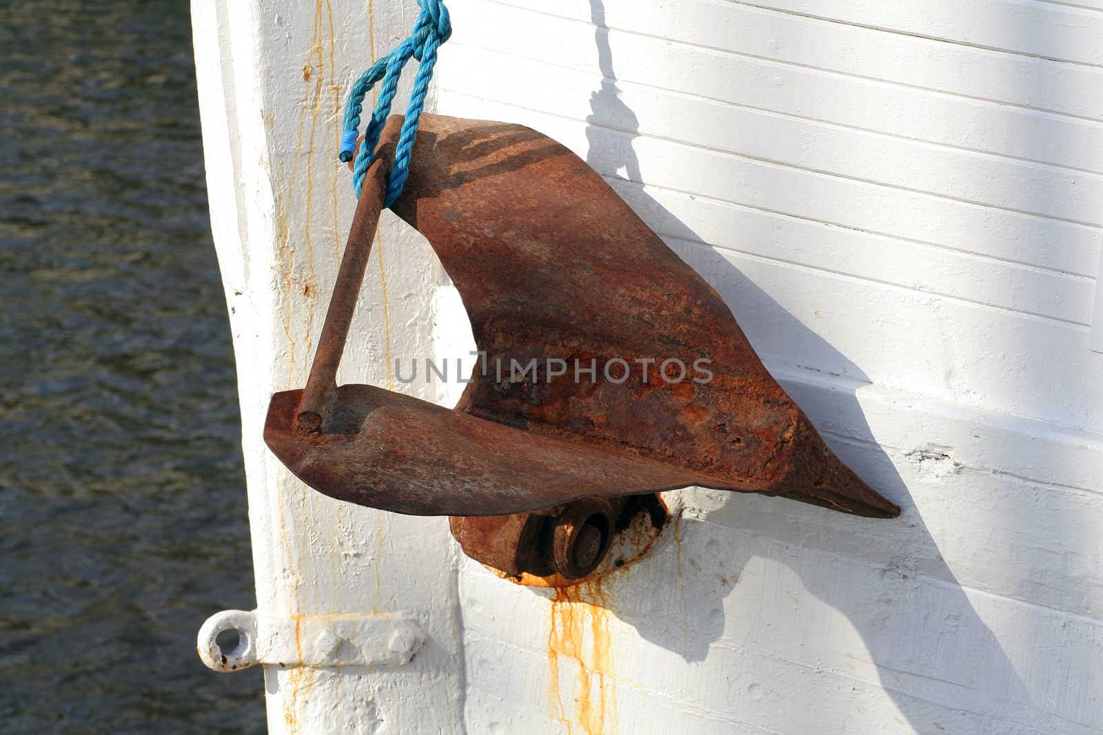 Very rusty anchor on an old abandoned fishing boat.