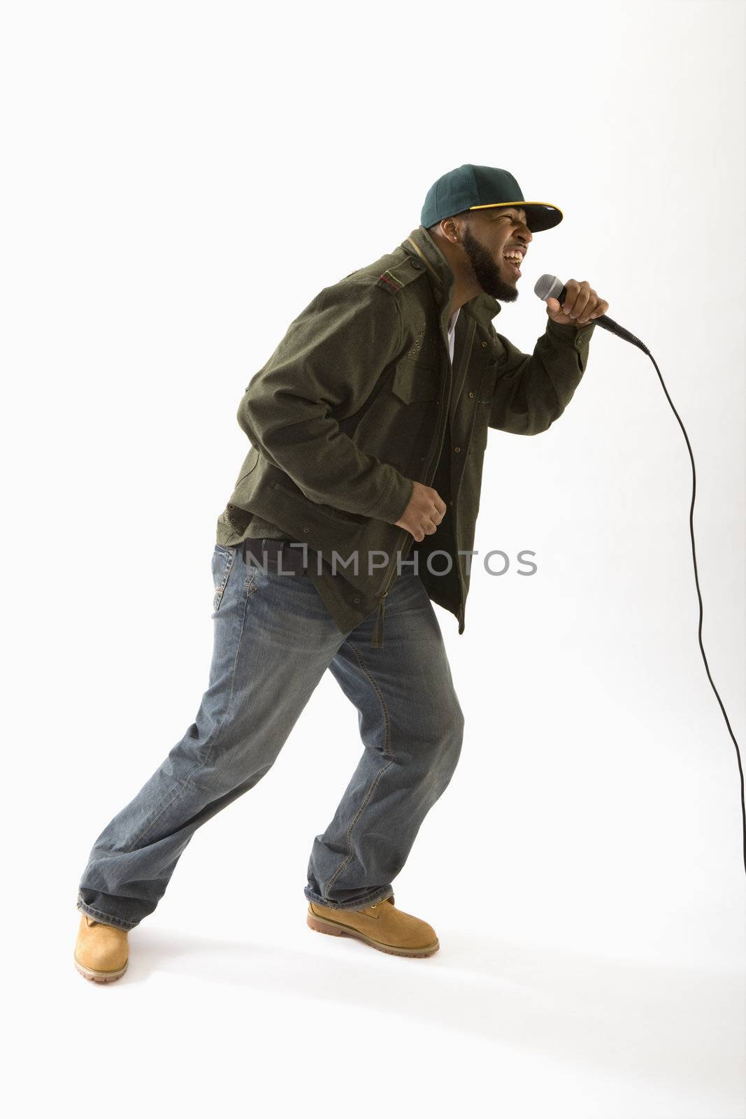 Man singing into microphone by edbockstock