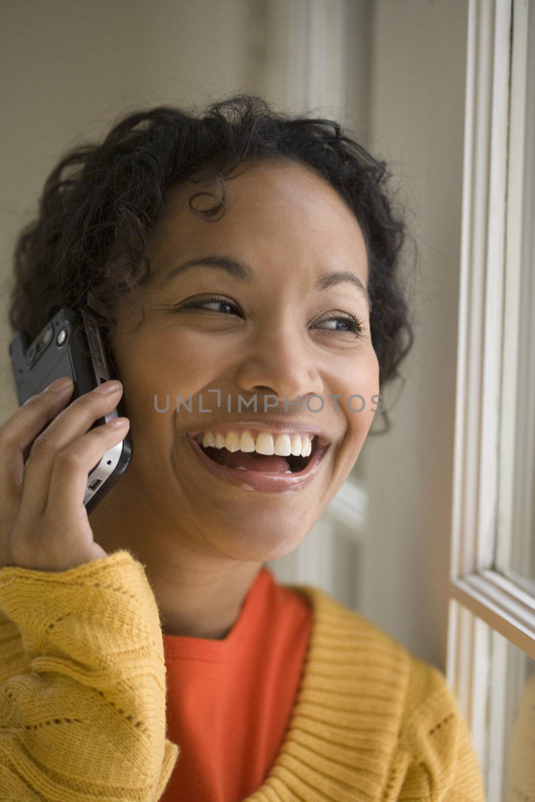 Pretty black woman on cell phone by edbockstock