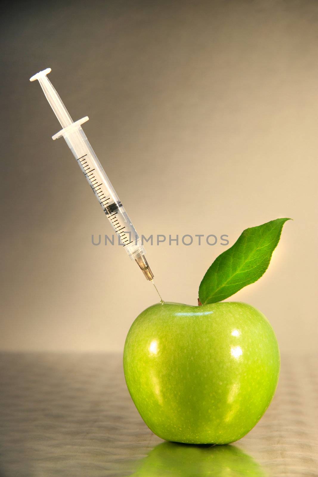 Close-up of syringe in green apple by Sandralise