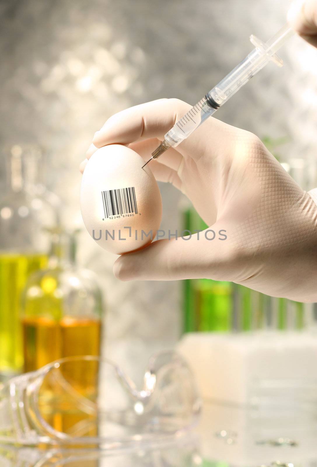 Close-up of syringe injecting egg for experiment