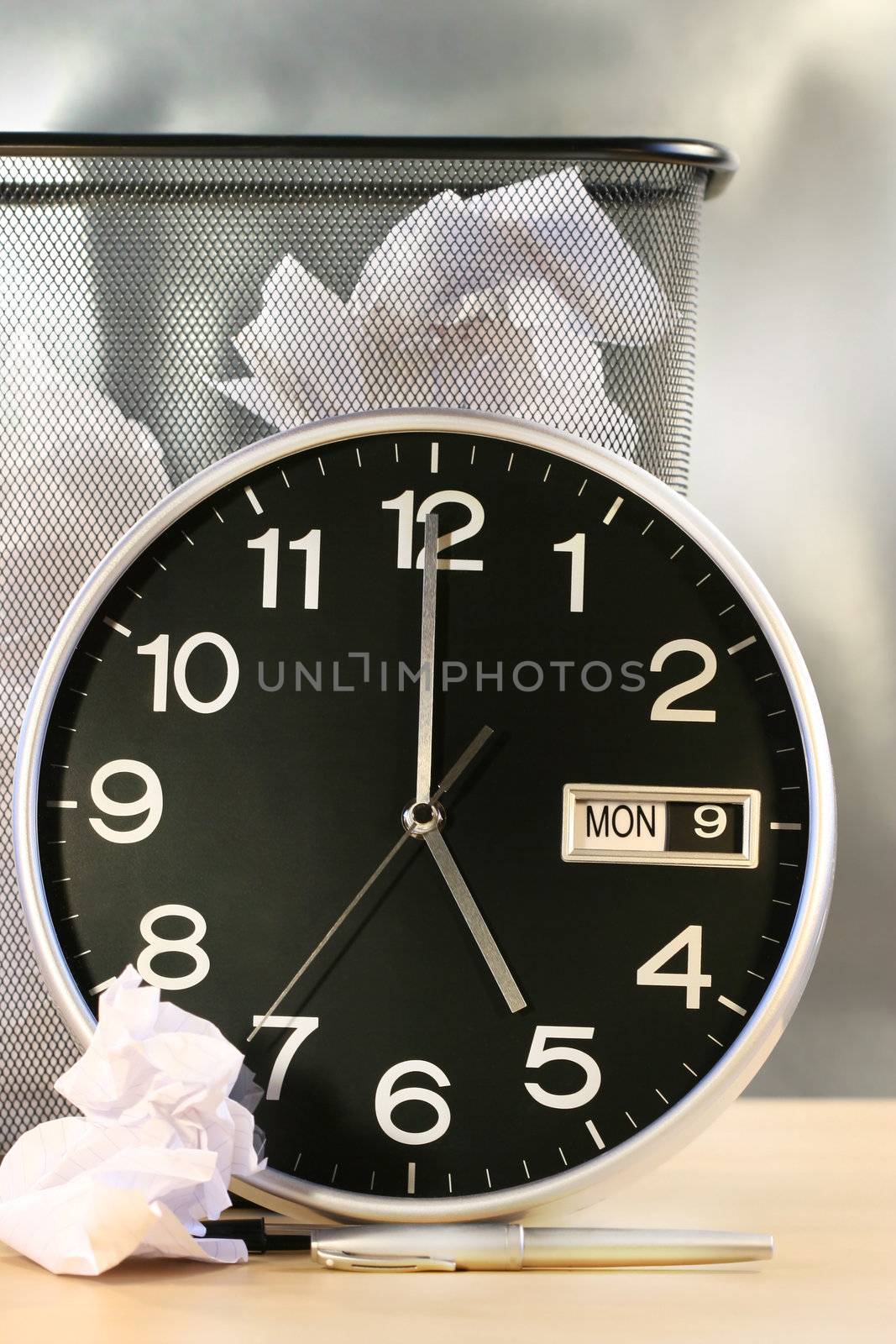 Clock showing time with waste paper basket in background