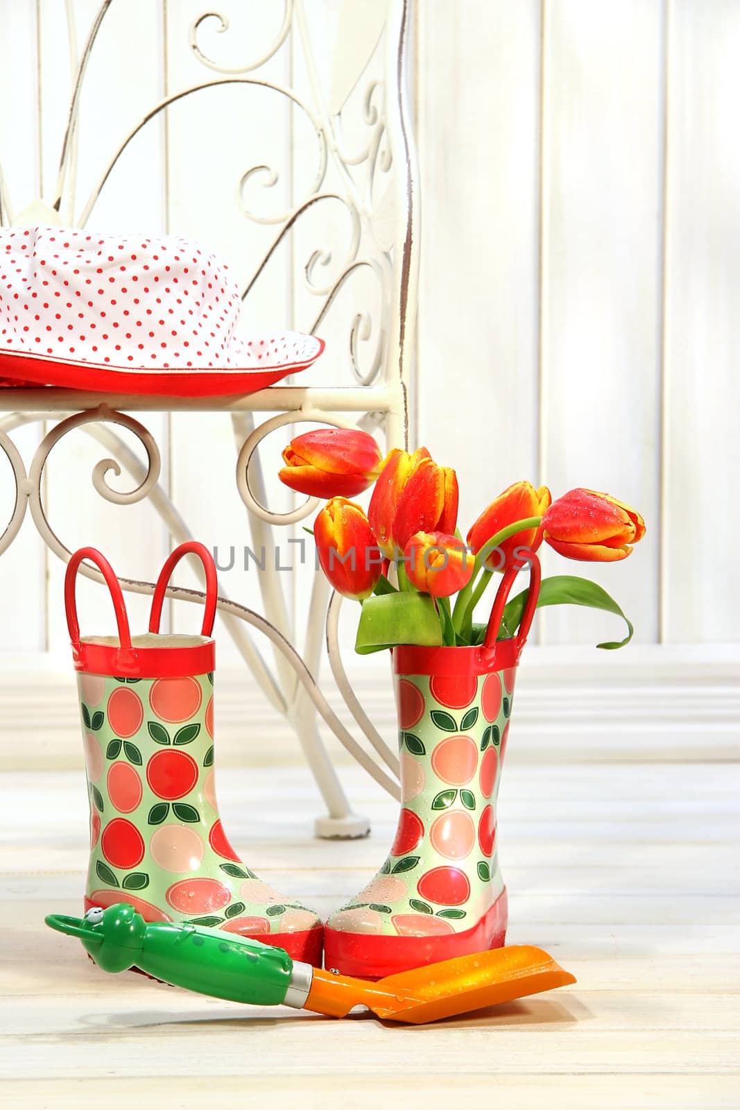 Iron chair with little rain boots and tulips  by Sandralise