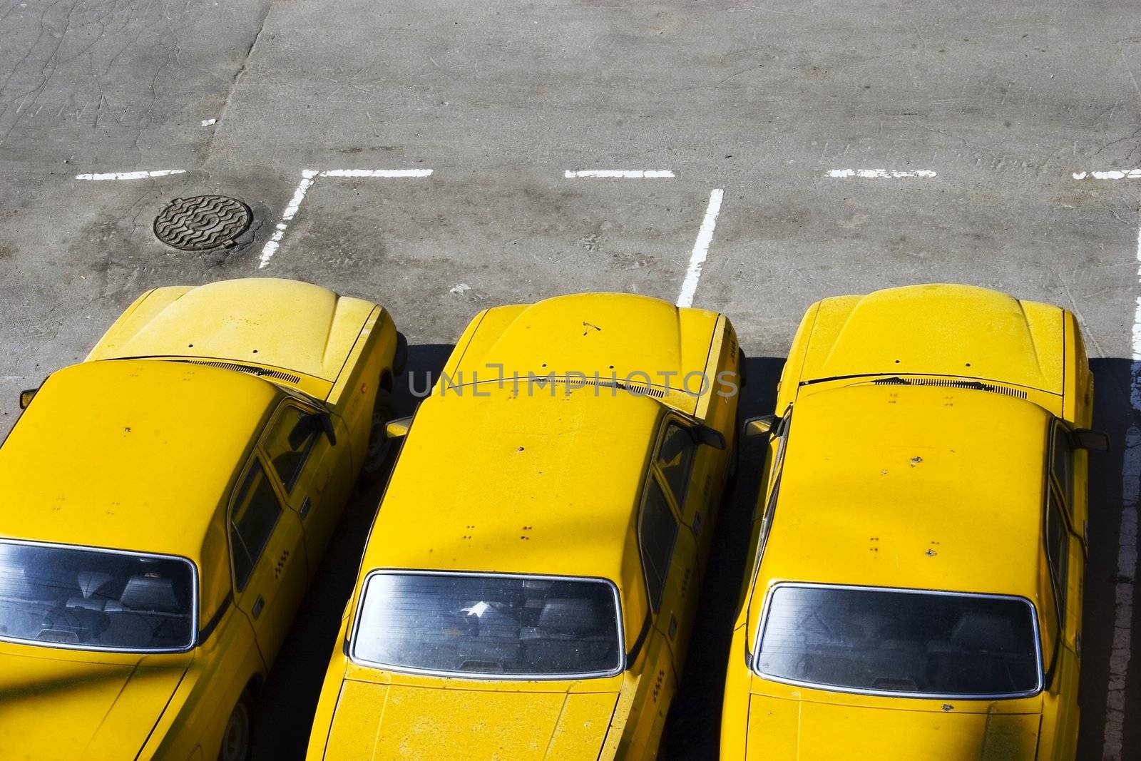 The three yellow taxi cars on parking