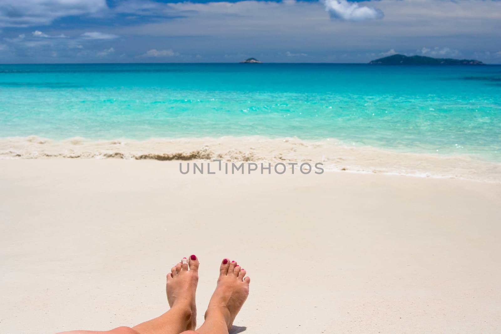 feets on white beach