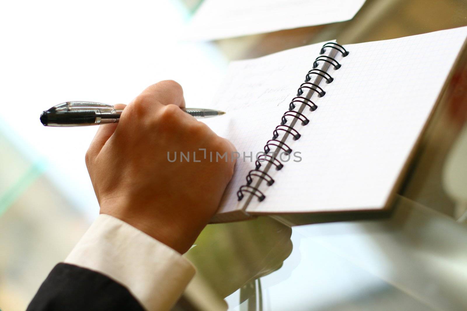 businessman hand write message in note 