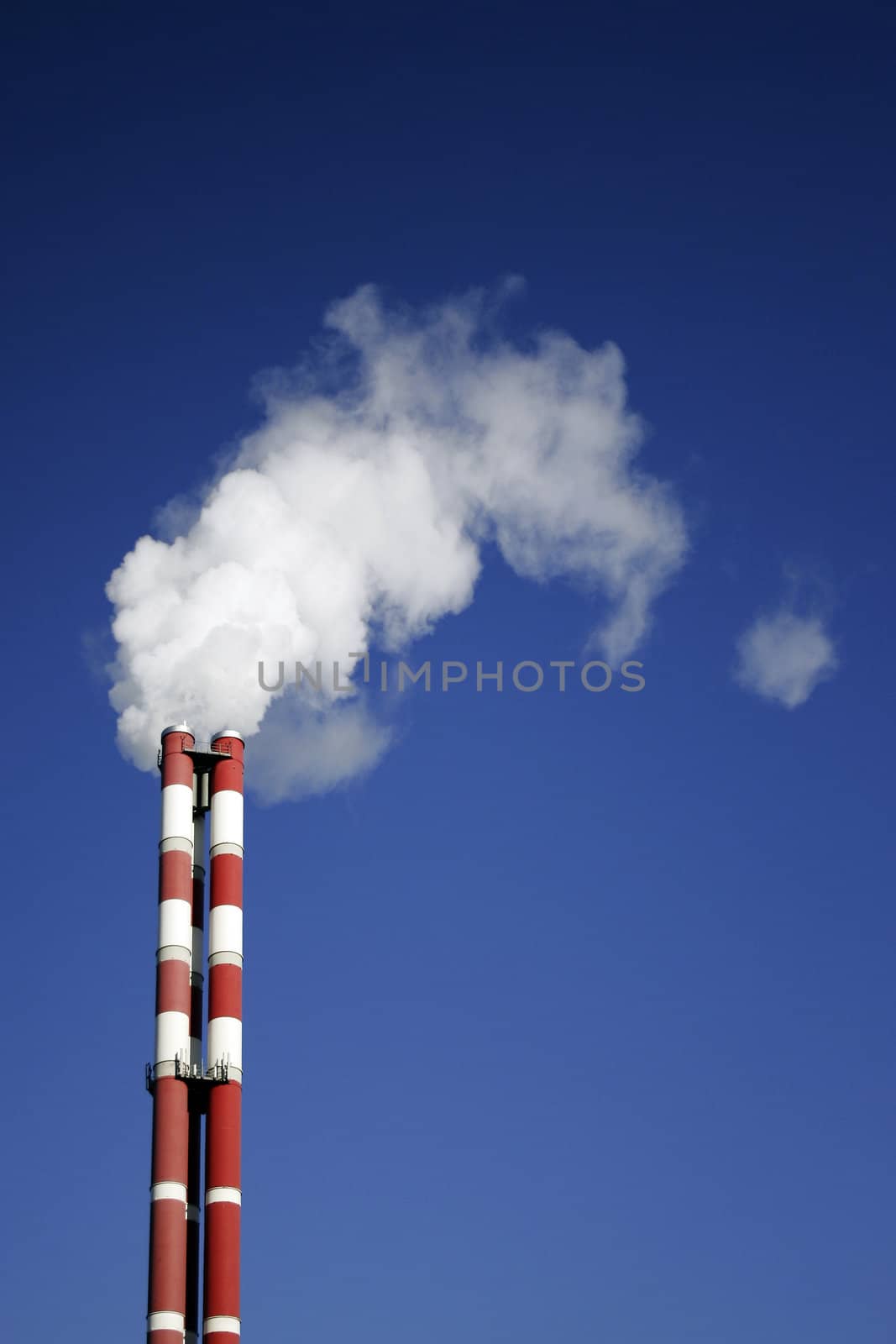 White vapour comes out of three pipes of the enterprise