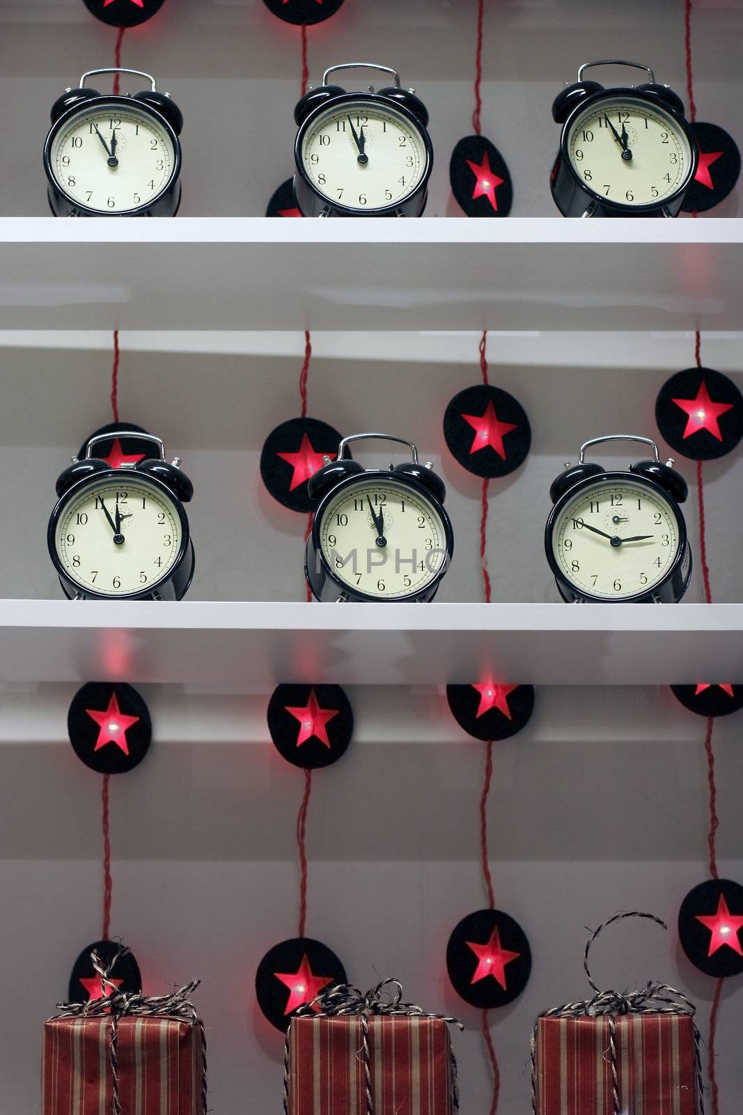 Several alarm clocks on bookshelf in shop