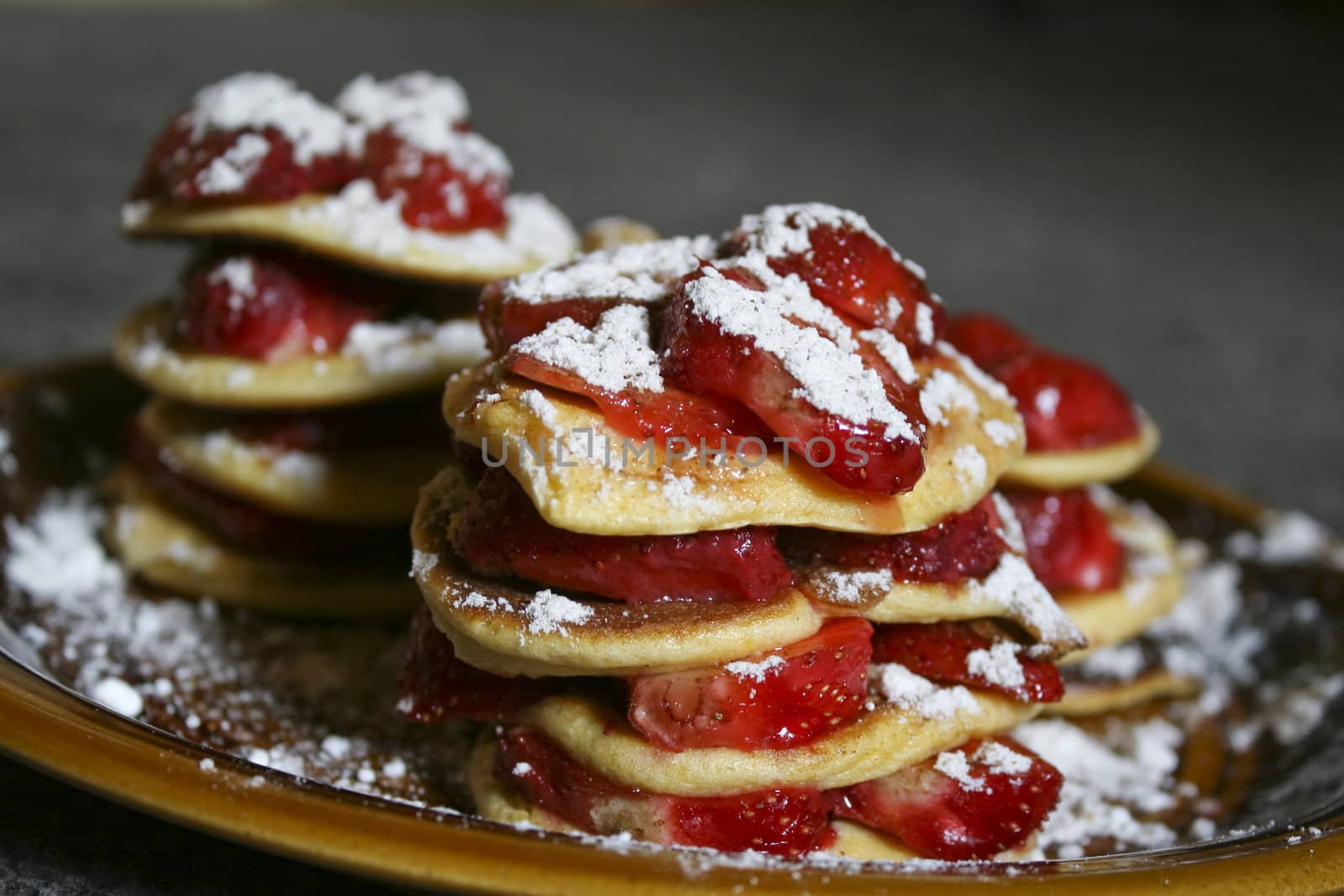 A picture of pancakes with strawberry.