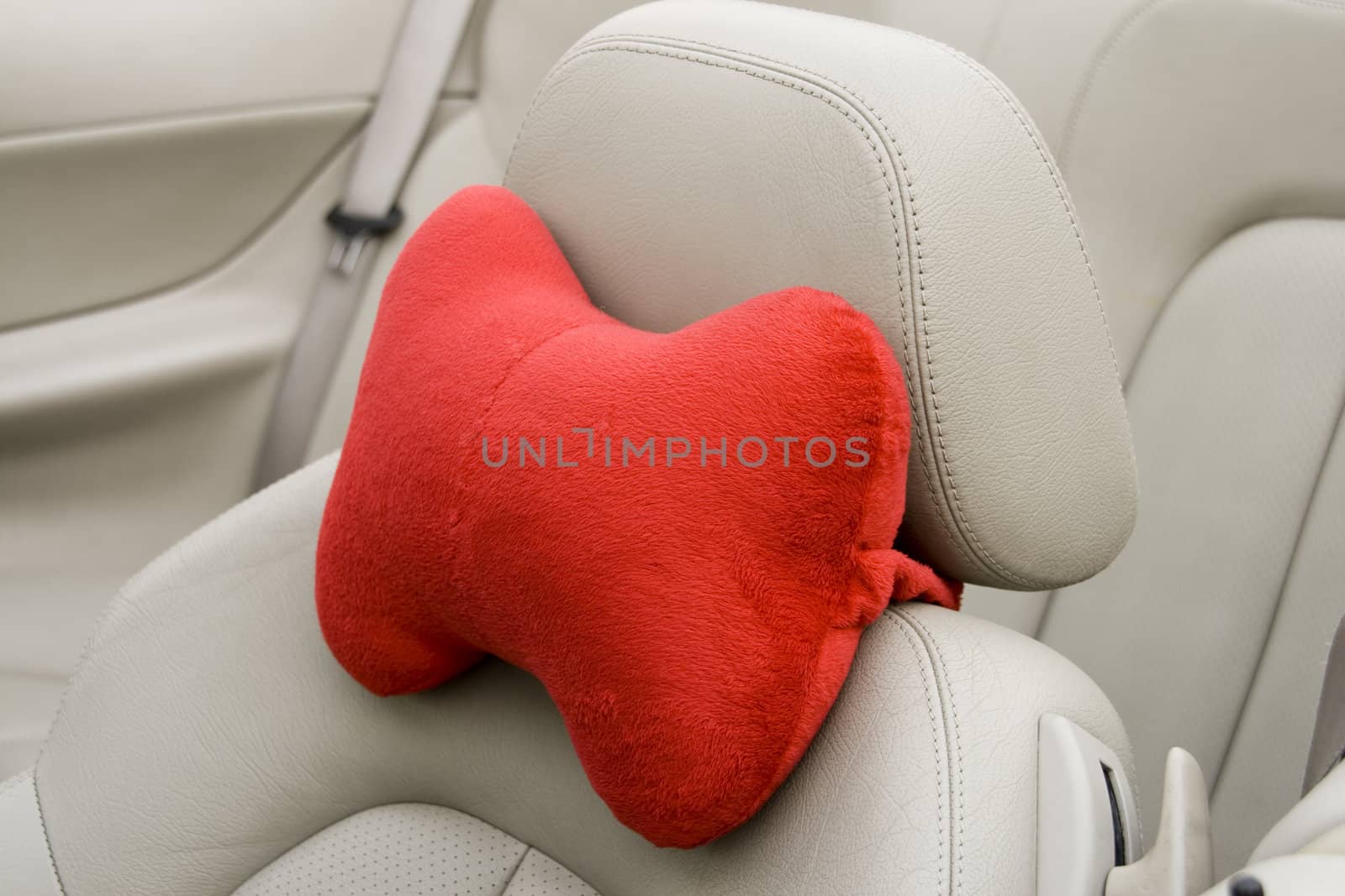 red pillow on the front seats of a modern car