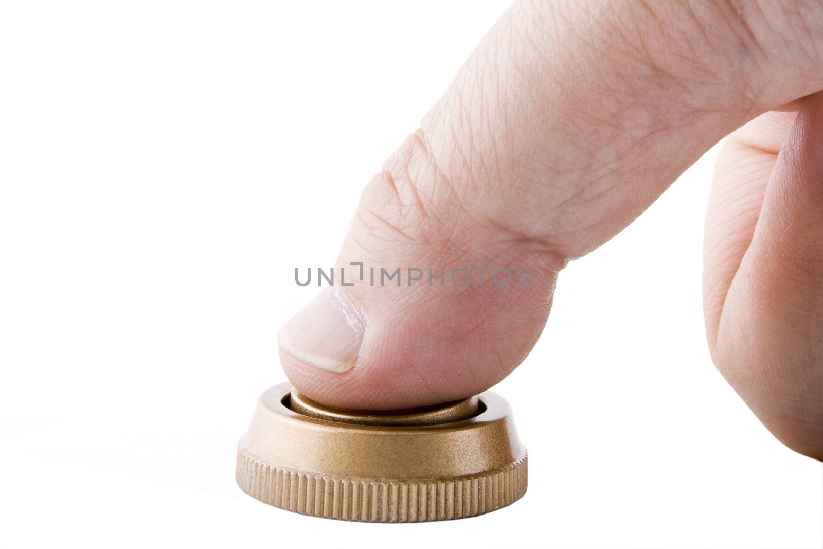 a finger pressing a golden button on white background