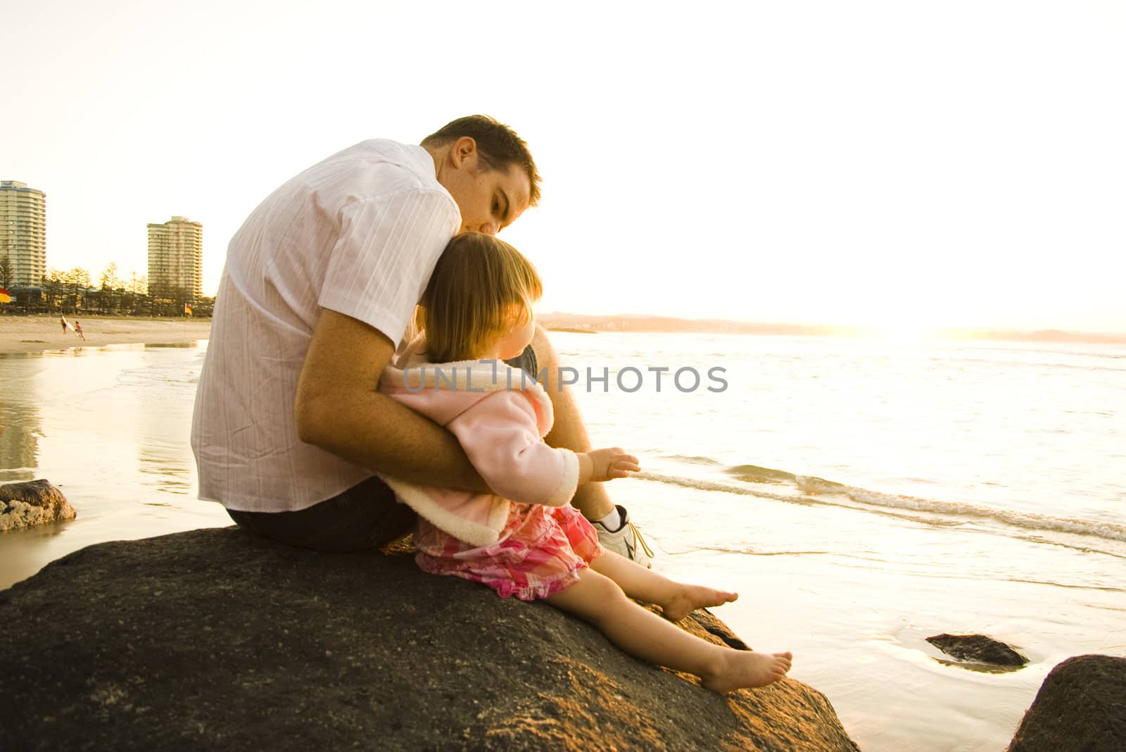 Father and daugher on rock at beach by angietakespics