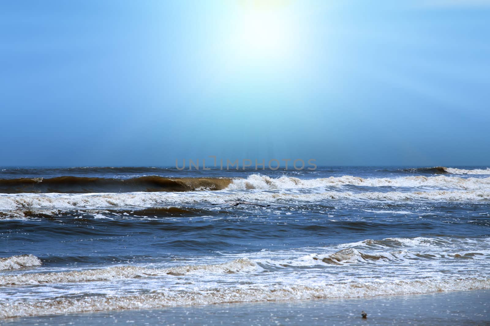 Sun shining over beautiful blue ocean shore