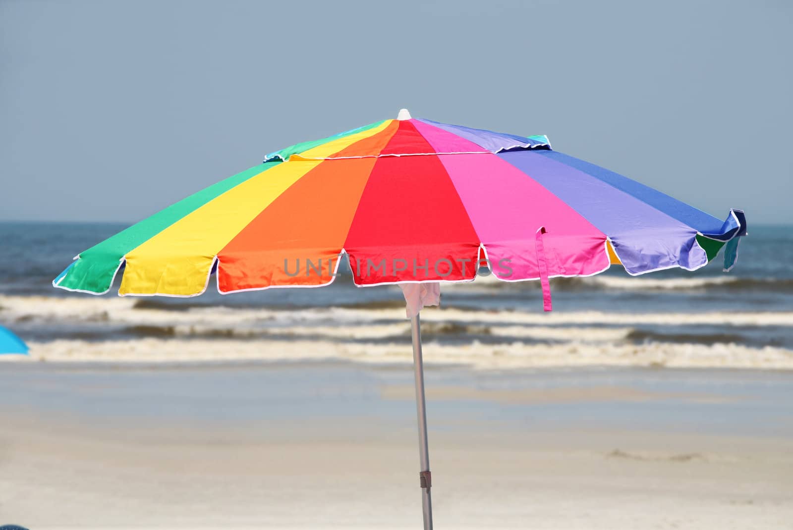 Colorful umbrella by beach by jarenwicklund