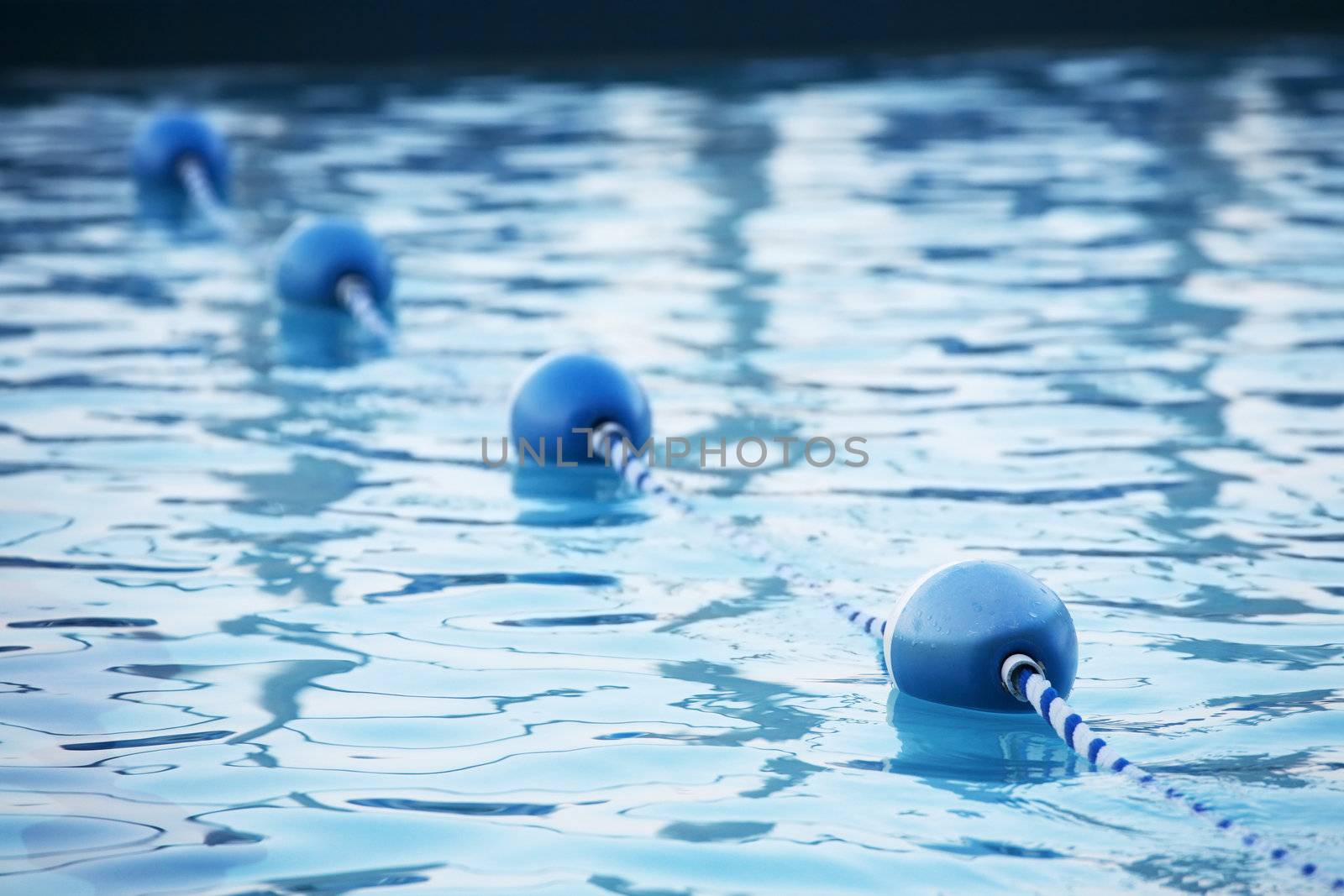 Blue water buoys in pool, shallow depth of field
