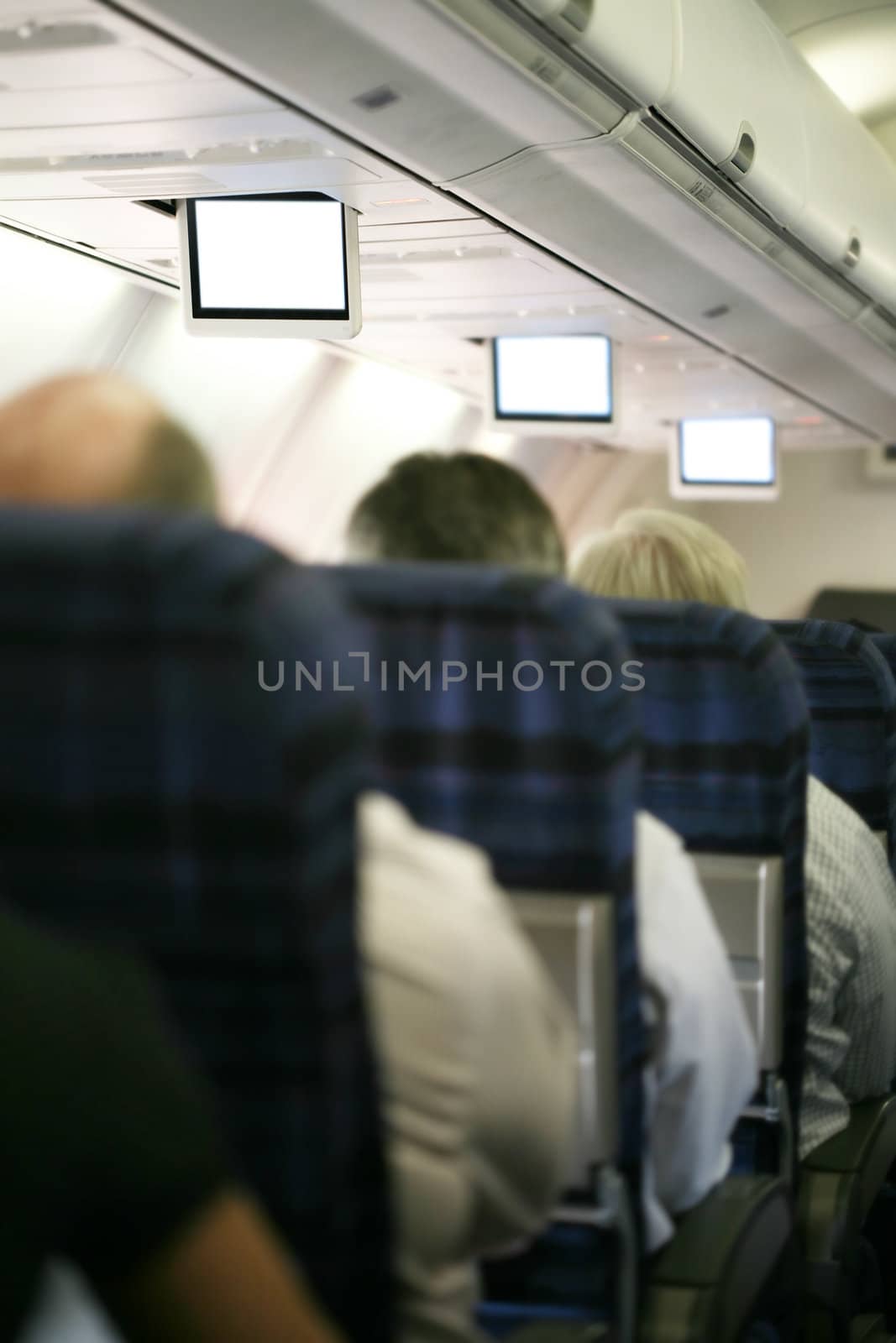Inside dark airplane, focus on tv screens, shallow DOF