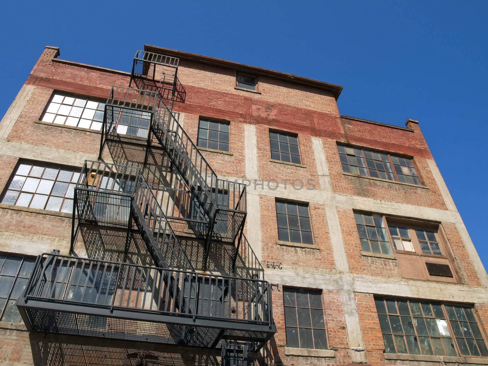 Old fire escape on an abandoned brick building.
