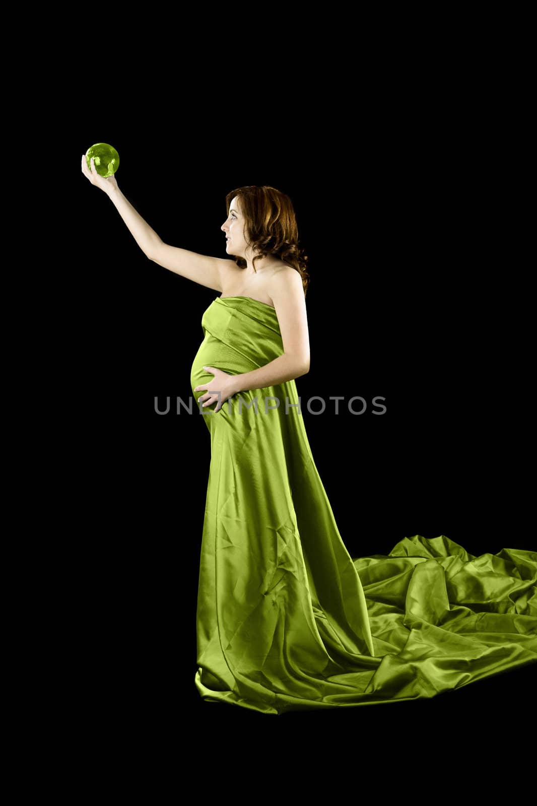 Beautiful Pregnant woman holding a Crystal Ball with a beautiful dress