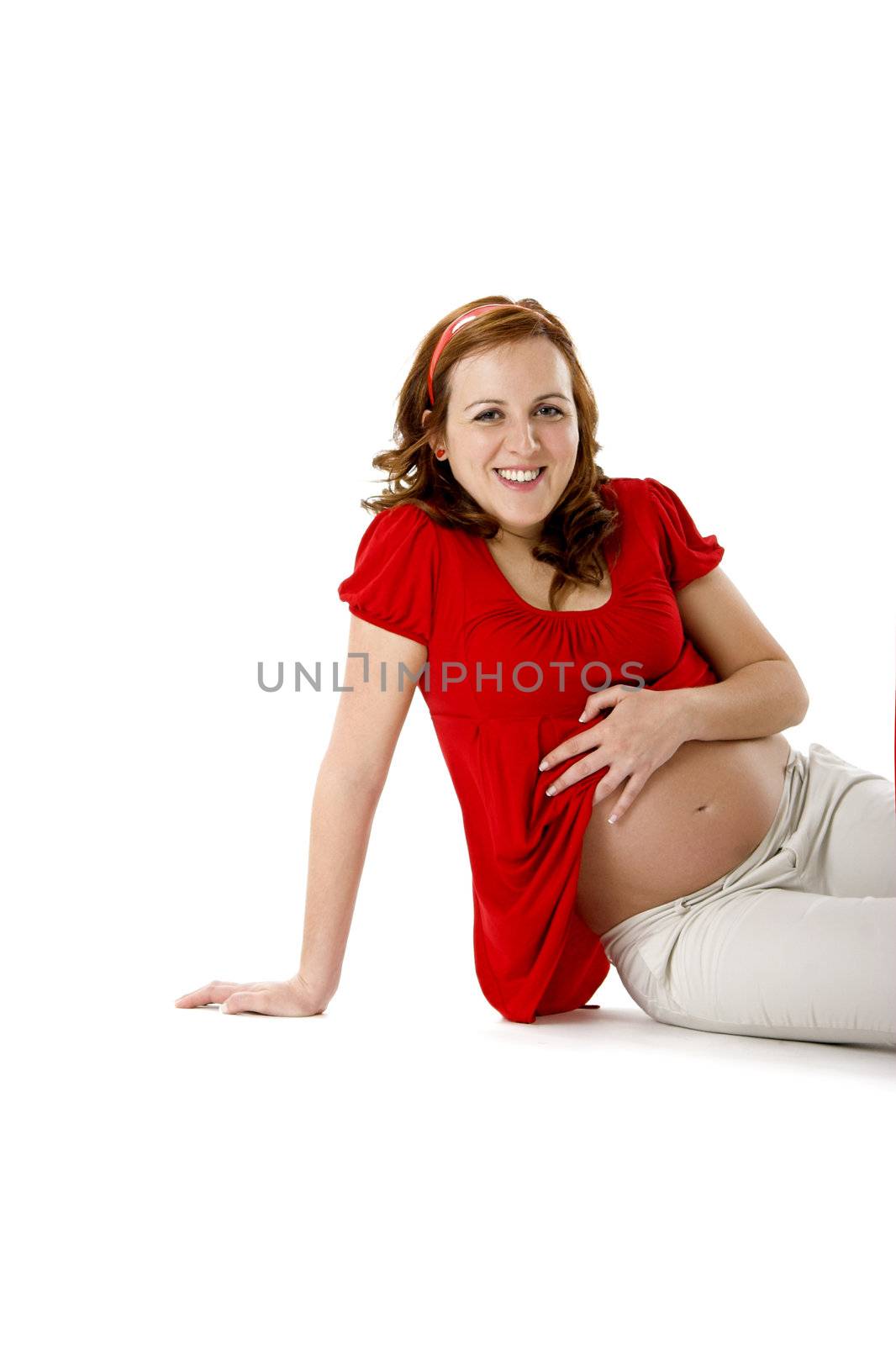 Beautiful pregnant woman on white enjoying this wonderful moment 
