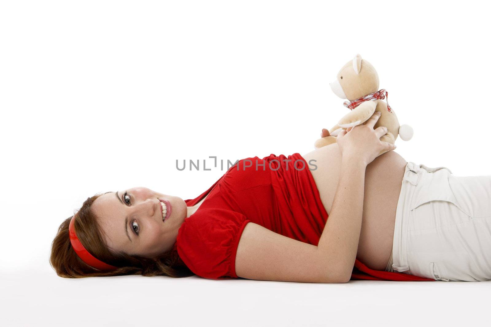 Beautiful pregnant woman with a teddy bear