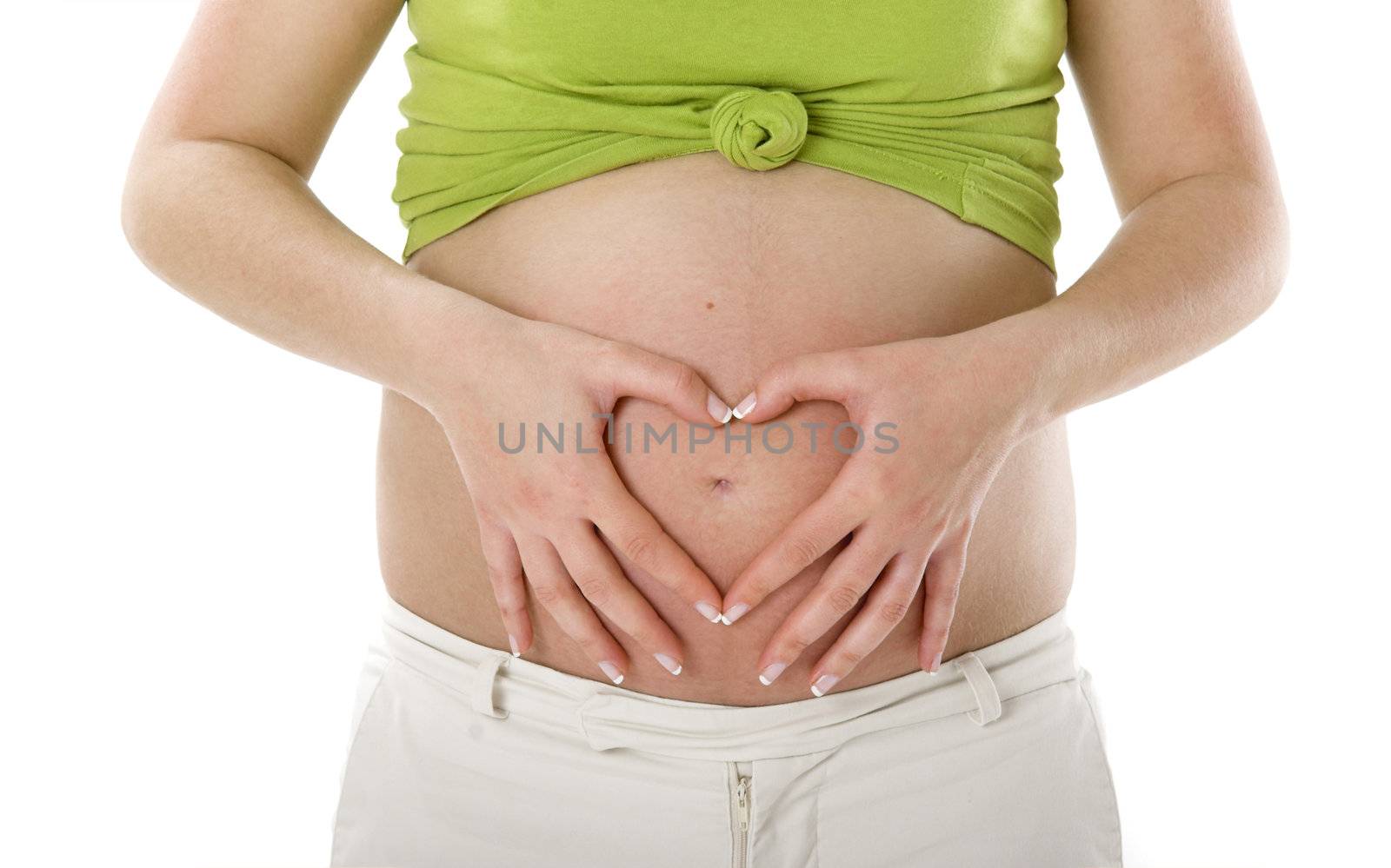 Pregnant woman showing her big tummy and making a Heart with the Hands