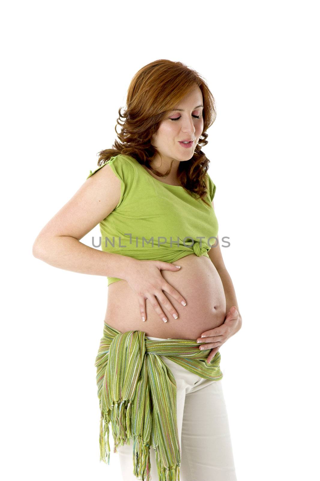 Beautiful pregnant woman on white enjoying this wonderful moment 