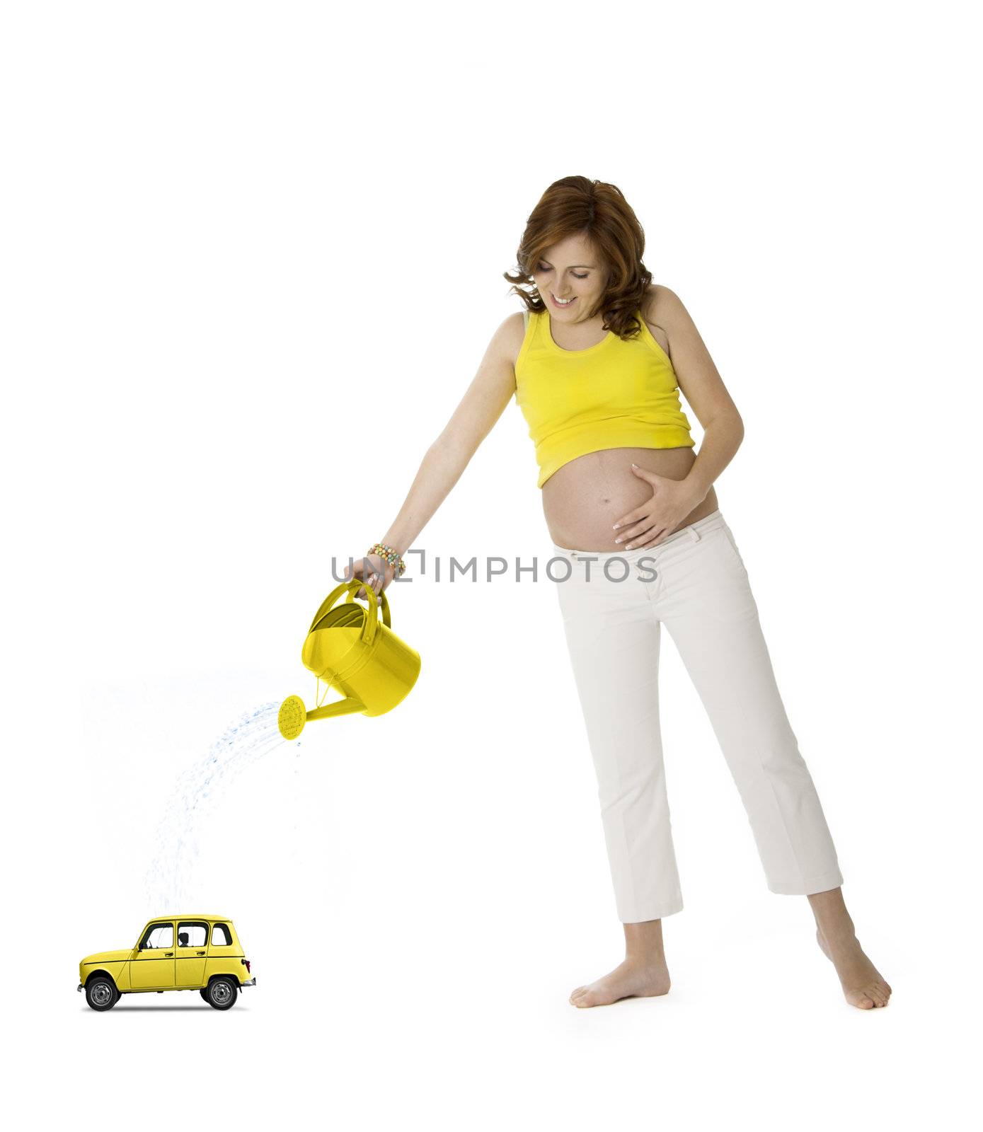 Beautiful pregnant woman watering a yellow car toy