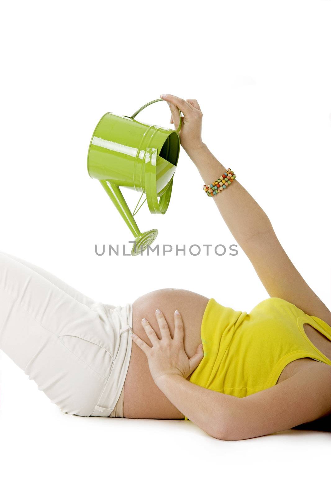 Beautiful pregnant woman watering her tummy to make the Baby growing  