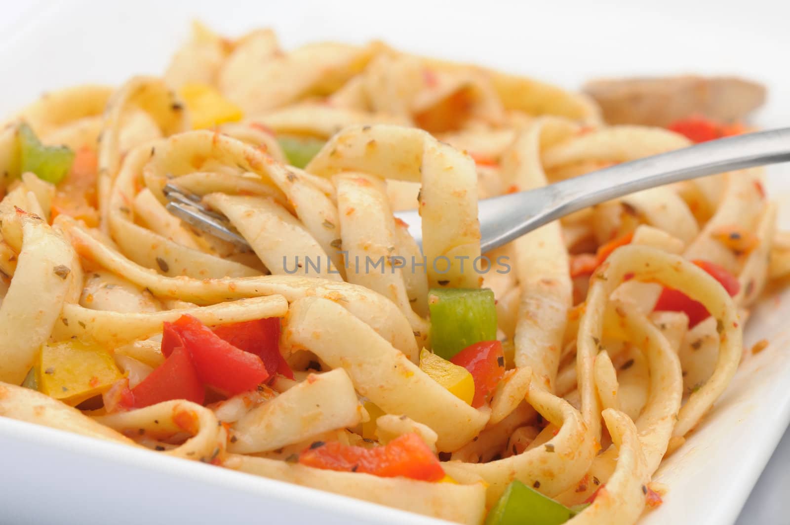 Fresh vegetable and pasta salad with a fork
