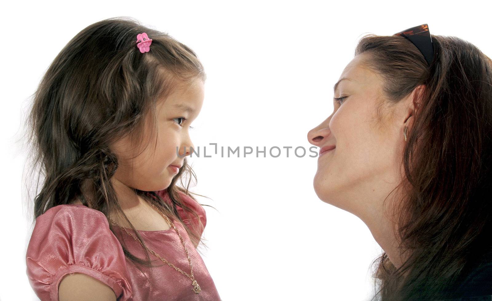 Mother and daughter look friend on friend and smile